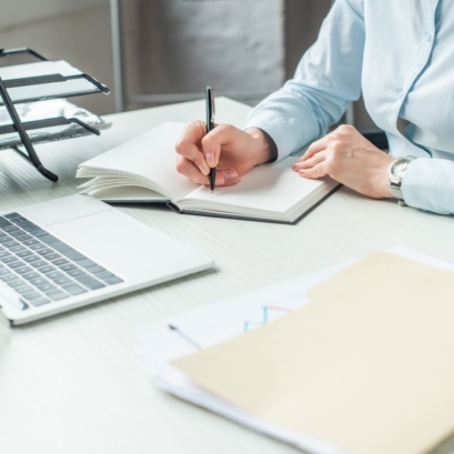 Estate planning lawyer working on laptop and notebook