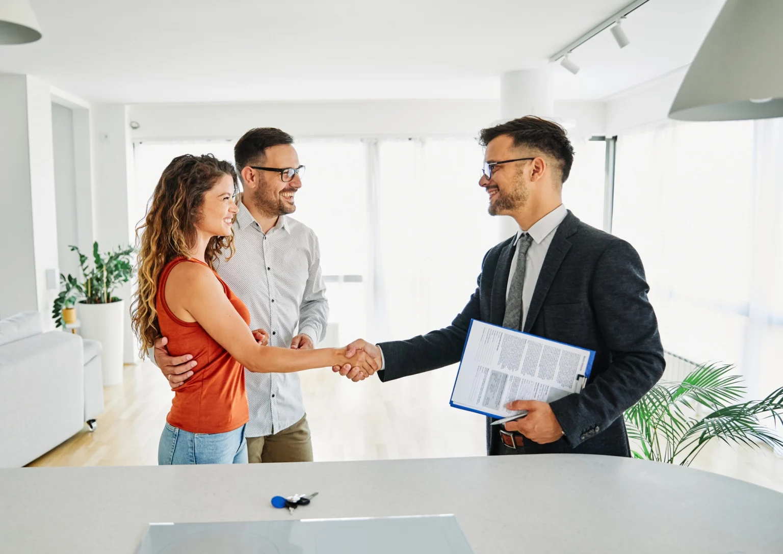 Property Lawyer shaking hands with young new homeowners in Sydney